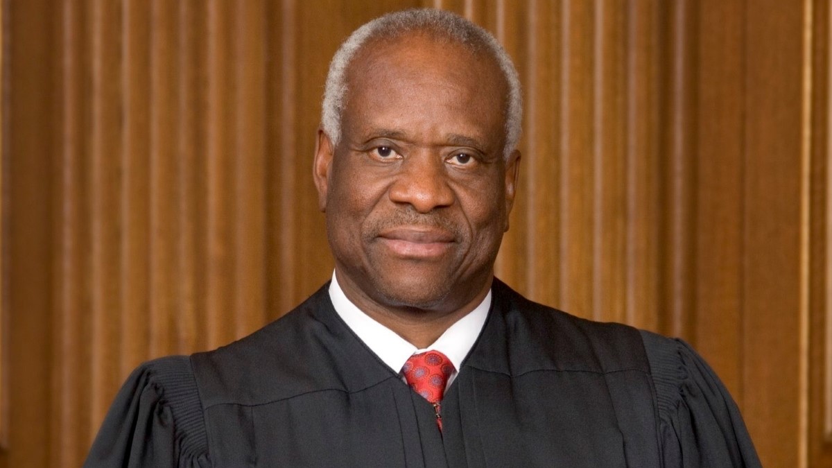Clarence Thomas sitting and posing for the picture