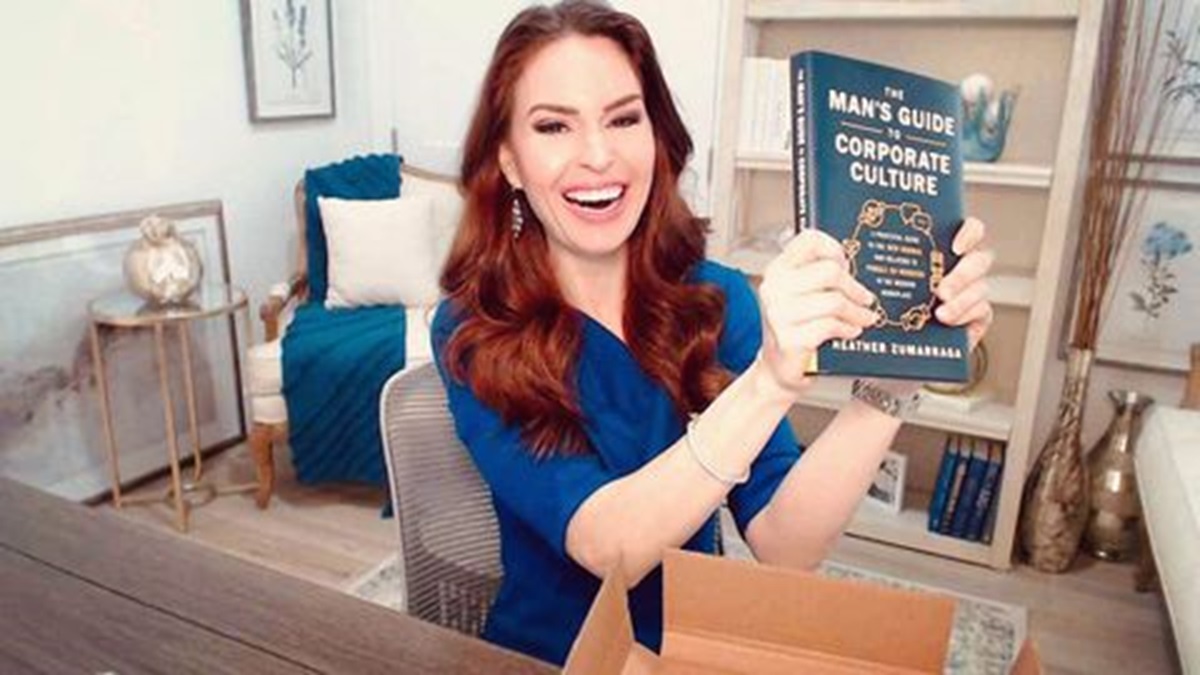 Heather Zumarraga showing a book by holding with her hands