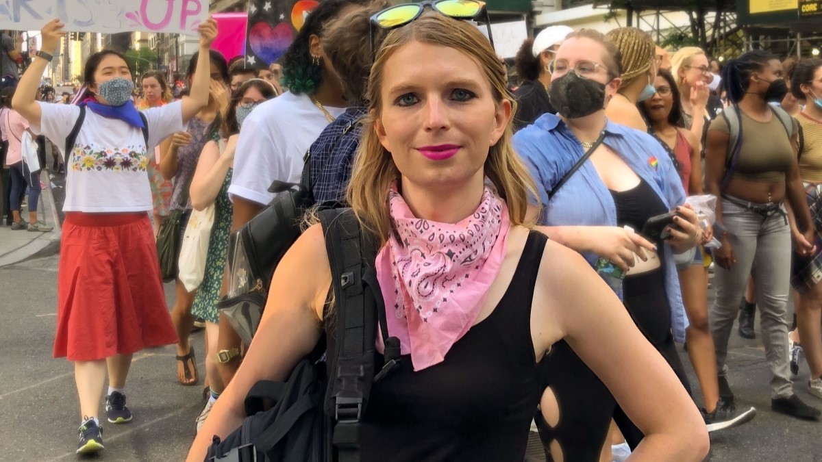 Chelsea Manning captured in black dress.